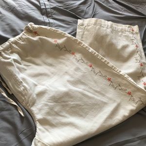 Capris beige with coral embroidery on sides.